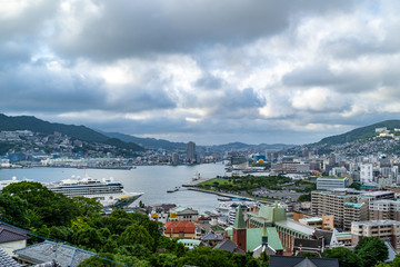 Naklejka na ściany i meble Timelapse of clouds move across Nagasaki's sky over the harbour