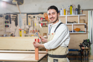 Small-Sized Companies, furniture and worker concept - Handsome young man working in the furniture factory