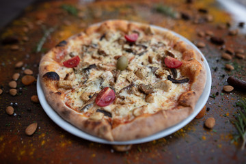Pizza Pollo Funghi isolated on a plate