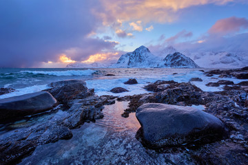 Coast of Norwegian sea on rocky coast in fjord on sunset