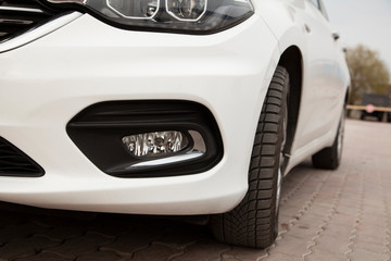 Obraz na płótnie Canvas white car auto headlight , front light of white car