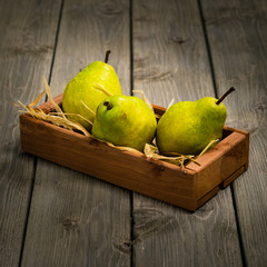 Fresh Green Williams Pears or Bartlett Pears on a Rustic Wooden table, Autumn Concept, Vintage...
