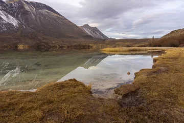 Papier peint photo  Scene view of sky reflected on lake against mountains during winter season in Patagonia, Esquel, Argentina  © Pedro Suarez