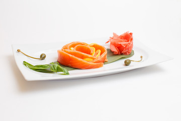 a salmon sushi on white plate