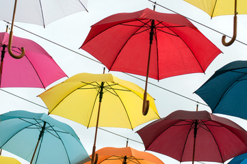 Closeup of colorful umbrella suspended in the street