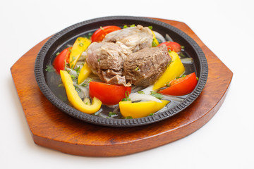 meat with vegetables on a white background