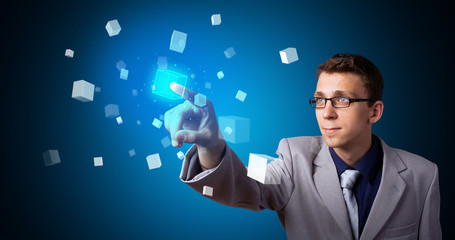 Man touching hologram screen displaying cube symbols