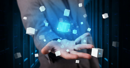 Person holding hologram projection displaying white cubes in server room