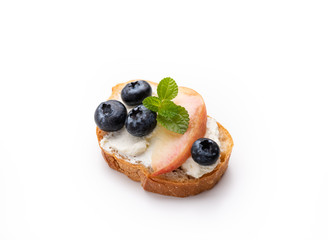 Bread toast with peach and blue berry on isolated white background