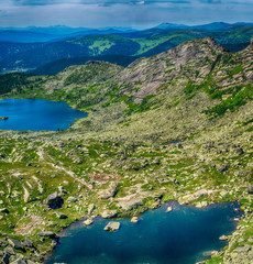 Beautiful view on tarn mountain lake and mointain range in Ergaki national park during summer day, Siberia, Russia