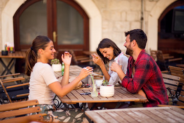 Friends talking in cafe at break
