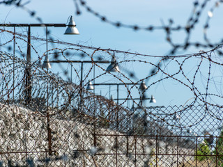 Fragment of barbed wire mounted above prison fence, Rummu quarry, Estonia