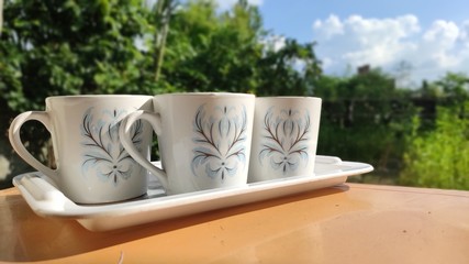 A group of cup in tray is on table in the morning time 