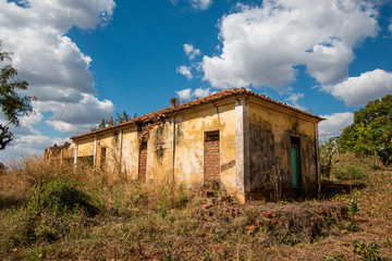 A weathered, run-down building on a sunny day in rural Mozambique, Africa