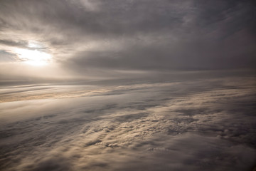 Clouds and sky as seen through window of an aircraft