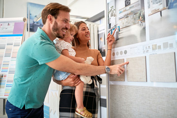 Young family shopping and looking at purchases in store for household.