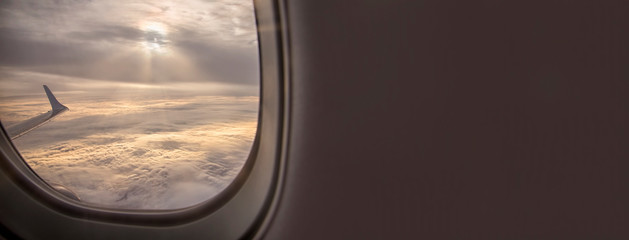 Fototapeta premium Clouds and sky as seen through window of an aircraft
