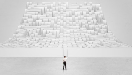 Businessman standing and thinking in front of a curved infinity maze