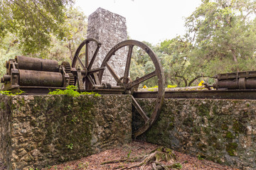 Medium shot of the chimney and steam engine at Yulee Sugar Mill Ruins State Park, in Homosassa, Florida. This park educates visitors about its slave and Civil War history.