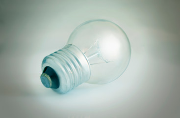 Glass electrical bulb on a light background with shading at the edges (1)