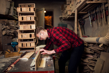 Image of busy carpenter working in his home workshop