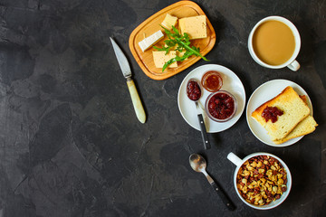 table with morning food, breakfast (tea, coffee, jam, toast, sandwich, cornflakes and more) menu concept. food background. copy save. Top view