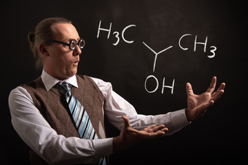 Professor presenting handdrawn chemical formula of Isopropylalcohol isopropanol 2-propanol