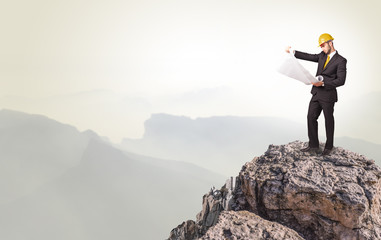 Young business person on the top of the rock