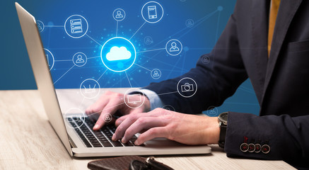 Businessman hand typing with cloud technology system and office symbol concept