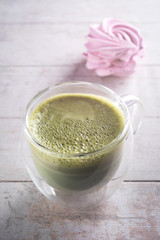 matcha latte on white background and marshmallow, close-up, copy space