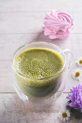 matcha latte, flowers and marshmallow on  white background , close-up, copy space