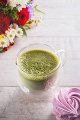 matcha latte, flowers and marshmallow on  white background , close-up, copy space