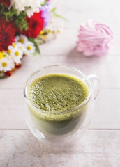 matcha latte, flowers and marshmallow on  white background , close-up, copy space