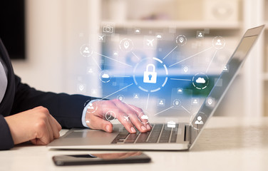 Business woman below chest working on laptop in a cozy homey environment with secured connection concept