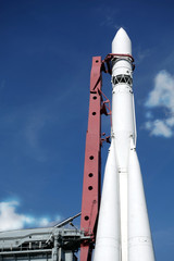 Spaceship on launch pad ready to fly into space vertical photo over blue sky