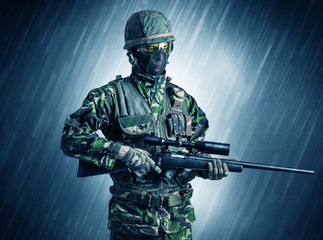 Armed soldier standing in rainy weather
