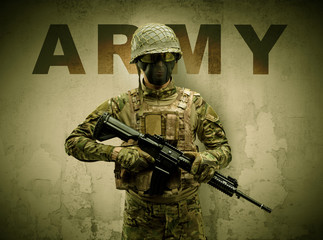 Uniformed armed soldier with damaged wall background