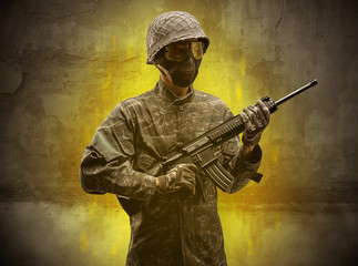 Hazard, menace soldier in a ruined crumbly building with arms on his hand
