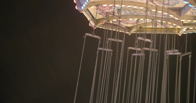 Close crop of swing ride at a carnival spinning around