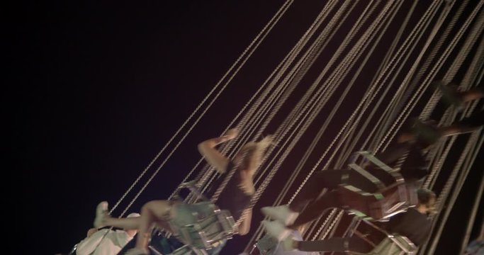 Close crop of swing ride at a carnival spinning around