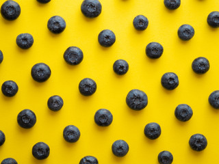 blueberries on a yellow background. summer and vitamins