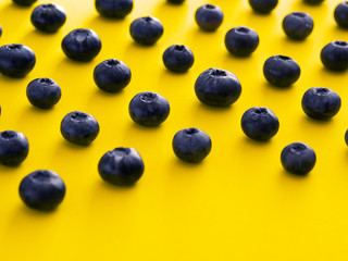 blueberries on a yellow background. summer and vitamins