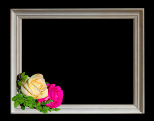white frame with yellow and pink roses isolated on black background.