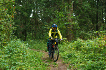 Fototapeta na wymiar bicycle hiker on a trail in a mountain forest