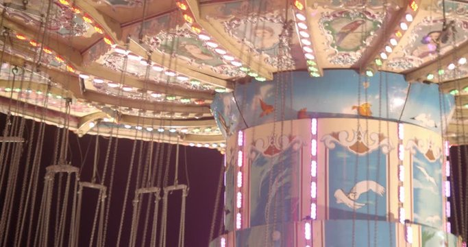Close crop of swing ride at a carnival spinning around
