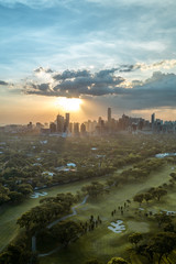 Golf course and Skyline of Manila, Philippines, in a beautiful sunset. - obrazy, fototapety, plakaty