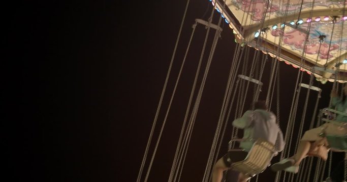 Close crop of swing ride at a carnival spinning around