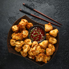 Chinese takeaway finger food Vegetable wontons with sweet chilli dip sauce and chop sticks