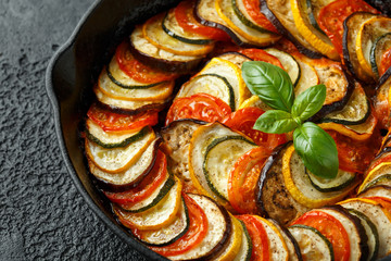 Ratatouille Vegetable Stew with zucchini, eggplants, tomatoes, garlic, onion and basil. on cast...