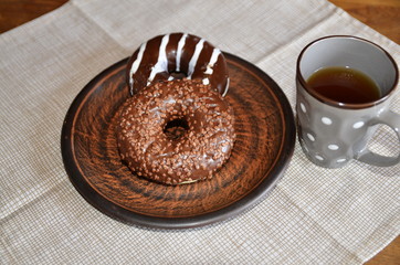 Morning, Provence style breakfast, tea, chocolate donuts and muffin.
